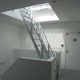 Ship ladder with guardrails for roof dome access Aluminium ship ladder used to access a flat roof via a Velux light dome.